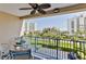 Relaxing balcony view showcasing lush landscaping, surrounding buildings, and a glimpse of the ocean at 5300 S Atlantic Ave # 12-403, New Smyrna Beach, FL 32169