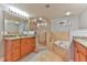 Elegant bathroom featuring a glass shower, soaking tub, and double vanity with granite countertop at 5300 S Atlantic Ave # 12-403, New Smyrna Beach, FL 32169