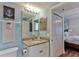 Bathroom view with granite countertop vanity, toilet and wall art, leading to a coastal design at 5300 S Atlantic Ave # 12-403, New Smyrna Beach, FL 32169