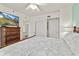 Bright, airy bedroom featuring wooden floors, a dresser with mounted TV and neutral tones at 5300 S Atlantic Ave # 12-403, New Smyrna Beach, FL 32169