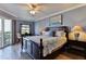 Relaxing bedroom featuring a comfortable king bed, a balcony, and scenic views at 5300 S Atlantic Ave # 12-403, New Smyrna Beach, FL 32169
