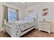 Cozy bedroom featuring a white bed, nightstand, ceiling fan and flooring at 5300 S Atlantic Ave # 12-403, New Smyrna Beach, FL 32169