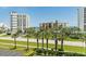 Beautiful beach view and beachfront view featuring manicured landscaping with palm trees and multiple buildings at 5300 S Atlantic Ave # 12-403, New Smyrna Beach, FL 32169