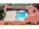 Aerial view of a community pool with lounge chairs and a covered seating area at 5300 S Atlantic Ave # 12-403, New Smyrna Beach, FL 32169