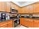 Kitchen featuring granite countertops, tile backsplash and stainless-steel appliances at 5300 S Atlantic Ave # 12-403, New Smyrna Beach, FL 32169