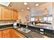 Kitchen with granite countertop bar open to the dining and living rooms at 5300 S Atlantic Ave # 12-403, New Smyrna Beach, FL 32169