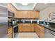 Well-equipped kitchen with granite countertops, stainless steel appliances, and ample cabinet space at 5300 S Atlantic Ave # 12-403, New Smyrna Beach, FL 32169