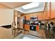 Well-lit kitchen featuring granite countertops and modern stainless-steel appliances at 5300 S Atlantic Ave # 12-403, New Smyrna Beach, FL 32169