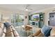Comfortable living room with sliding glass doors to balcony and stylish furniture and decor at 5300 S Atlantic Ave # 12-403, New Smyrna Beach, FL 32169