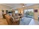 Inviting living room featuring a leather sofa, balcony access, and a mirrored wall at 5300 S Atlantic Ave # 12-403, New Smyrna Beach, FL 32169