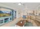 Inviting living room featuring a comfortable leather sofa, stylish furniture, and a seamless flow into the kitchen area at 5300 S Atlantic Ave # 12-403, New Smyrna Beach, FL 32169