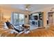 Comfortable living room featuring a custom entertainment center and balcony access at 5300 S Atlantic Ave # 12-403, New Smyrna Beach, FL 32169