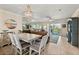 Open-concept living and dining area with sliding glass doors that lead to a large balcony at 5300 S Atlantic Ave # 12-403, New Smyrna Beach, FL 32169