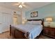 Bedroom with a bed, ceiling fan, wall art, and nightstands with lamps on either side at 5300 S Atlantic Ave # 12-403, New Smyrna Beach, FL 32169