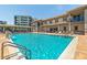 Inviting pool area featuring lounge chairs, covered seating, and well-maintained grounds at 5300 S Atlantic Ave # 12-403, New Smyrna Beach, FL 32169