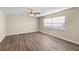 A large bedroom with wood-look flooring, a ceiling fan, and a window at 541 Northwestern Ave, Altamonte Springs, FL 32714