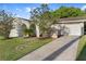 Inviting single-story home featuring landscaping, a covered entryway, and an attached garage at 541 Northwestern Ave, Altamonte Springs, FL 32714