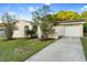 Attractive single-story home featuring an arched entryway, landscaping, and an attached garage at 541 Northwestern Ave, Altamonte Springs, FL 32714
