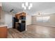 An open kitchen featuring black appliances, wood cabinets, granite countertops and modern lighting at 541 Northwestern Ave, Altamonte Springs, FL 32714