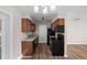 A well-lit kitchen with wood cabinets, granite countertops, and black appliances at 541 Northwestern Ave, Altamonte Springs, FL 32714