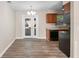 An open kitchen featuring a dining area, French doors, and sleek black appliances at 541 Northwestern Ave, Altamonte Springs, FL 32714