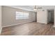 A living room featuring wood-look flooring, a ceiling fan, and neutral paint at 541 Northwestern Ave, Altamonte Springs, FL 32714