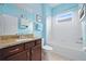 Bathroom with a wooden vanity, granite countertop, mirror, and a shower-tub combo at 5513 Estero Loop, Port Orange, FL 32128