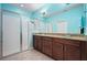 Bathroom with a glass shower and a double vanity with a granite countertop and wooden cabinets at 5513 Estero Loop, Port Orange, FL 32128