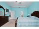 A spacious bedroom featuring tray ceilings, blue walls, a wooden bed, and matching wooden furniture at 5513 Estero Loop, Port Orange, FL 32128