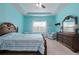A spacious bedroom featuring tray ceilings, blue walls, a wooden bed, and matching wooden furniture at 5513 Estero Loop, Port Orange, FL 32128