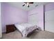 Cozy bedroom featuring light purple walls and a comfortable bed with floral patterned bedding at 5513 Estero Loop, Port Orange, FL 32128