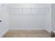 Empty walk-in closet with carpeted floors and wire shelving, ready for customization at 5513 Estero Loop, Port Orange, FL 32128