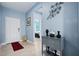 Welcoming foyer with blue walls, decorative accents, and views into other rooms at 5513 Estero Loop, Port Orange, FL 32128