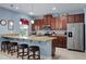 Modern kitchen featuring granite countertops, stainless steel appliances, and breakfast bar at 5513 Estero Loop, Port Orange, FL 32128