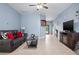 Comfortable living room with tile flooring, ceiling fan, and plenty of natural light at 5513 Estero Loop, Port Orange, FL 32128