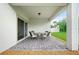 Cozy covered patio with brick flooring, ideal for outdoor dining and relaxation at 5513 Estero Loop, Port Orange, FL 32128