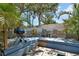 Backyard wooden deck with chairs, small tables, grill, and white fence offer outdoor relaxation at 5967 Plantera Ct, Port Orange, FL 32127