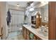 Traditional bathroom with double sinks, vanity, and shower-tub combo at 5967 Plantera Ct, Port Orange, FL 32127