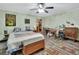 Bedroom with vintage decor, ceiling fan, and hardwood floors at 5967 Plantera Ct, Port Orange, FL 32127