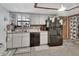 Efficient kitchen featuring white cabinets, a black refrigerator, and a view to the adjacent room at 5967 Plantera Ct, Port Orange, FL 32127