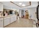 Open-concept kitchen leading to the living area with neutral flooring at 5967 Plantera Ct, Port Orange, FL 32127