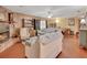 Inviting living room with a brick fireplace, comfortable seating, and a view of the dining area at 5967 Plantera Ct, Port Orange, FL 32127