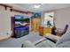 Comfortable den with a large television, desk, and relaxing seating area at 5967 Plantera Ct, Port Orange, FL 32127