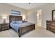 Inviting bedroom with a large bed, matching nightstands, and an ensuite bathroom at 6254 Woodhaven Village Dr, Port Orange, FL 32128