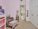 Bedroom featuring pink walls, neutral carpet and chair at 6254 Woodhaven Village Dr, Port Orange, FL 32128