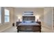 Well-lit bedroom featuring a large bed, bedside tables with lamps, and plantation shutters at 6254 Woodhaven Village Dr, Port Orange, FL 32128