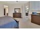 Spacious bedroom with plush carpet, walk in closet, and view into living space at 6254 Woodhaven Village Dr, Port Orange, FL 32128