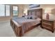Comfortable bedroom featuring plush carpet, natural light, and matching nightstands at 6254 Woodhaven Village Dr, Port Orange, FL 32128