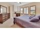 Serene bedroom features plush carpet, natural light, a dresser, and an attached workspace at 6254 Woodhaven Village Dr, Port Orange, FL 32128
