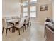 Bright dining room with ample seating and natural light with views to the kitchen at 6254 Woodhaven Village Dr, Port Orange, FL 32128